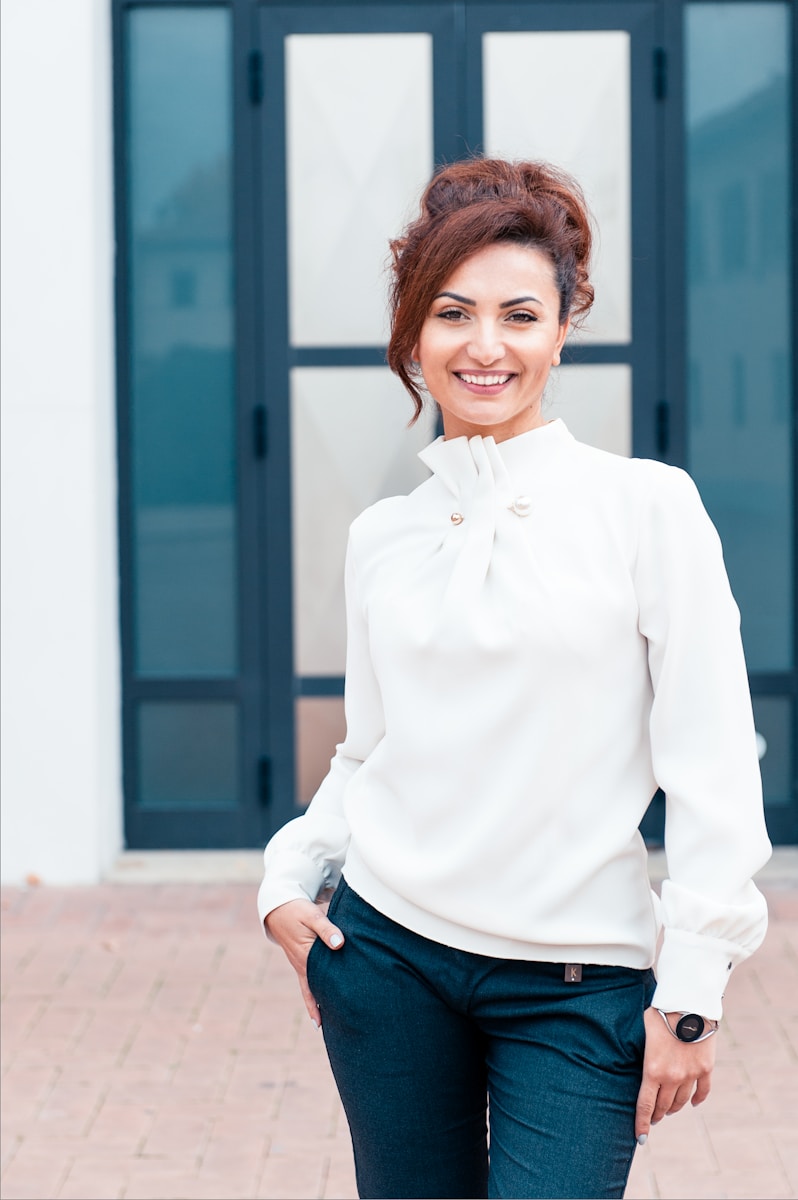 independent agent woman in white dress shirt and blue denim jeans smiling